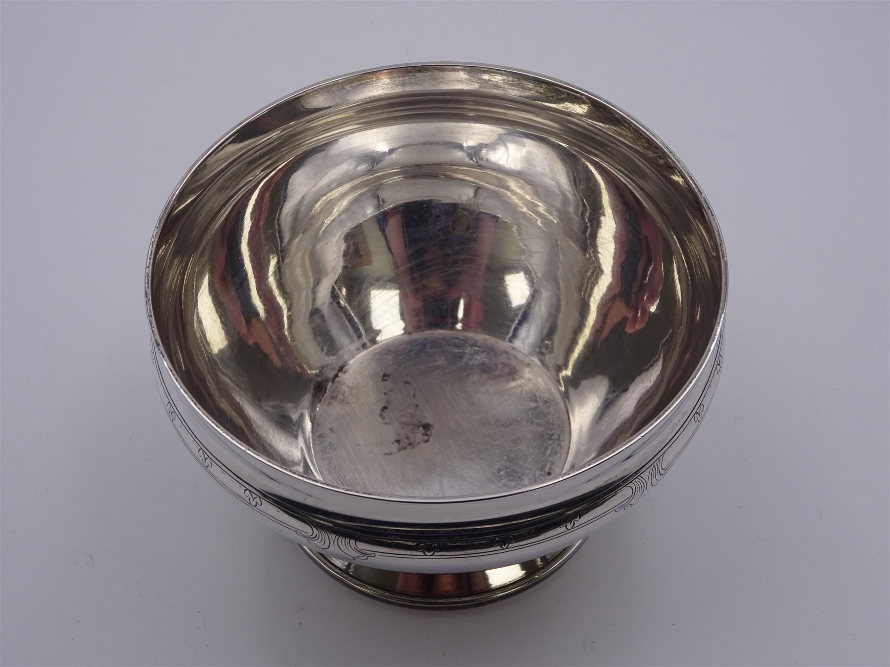 Small 1930's silver bowl, of circular form with engraved band beneath rim, upon a spreading circular foot, hallmarked William Comyns & Sons Ltd, London 1933, also stamped for retailer Z. Barraclough & Sons Ltd, H6.5cm D10.5cm, approximate weight 7.07 ozt (220 grams)