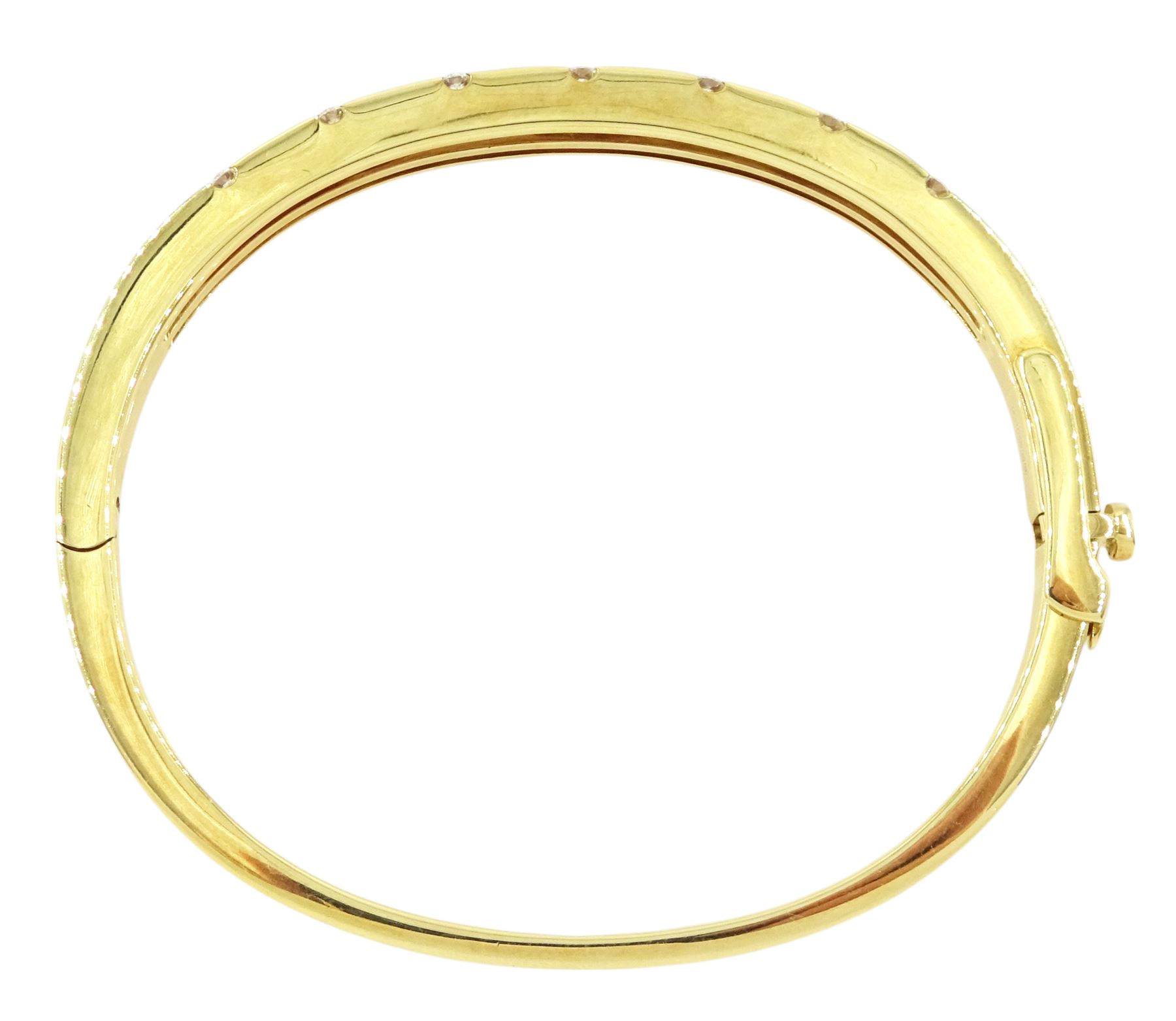 Roberto Coin 'Parisienne' 18ct gold three row round brilliant cut diamond bangle, with a signature round cut ruby to the underside and ruby set clasp, Birmingham 2006, boxed