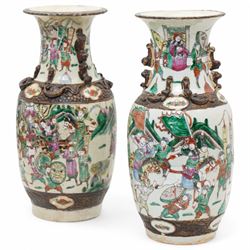 Pair of late 19th/Early 20th century Cantonese baluster vases decorated with warriors and mythical beast handles on a white ground H44cm 