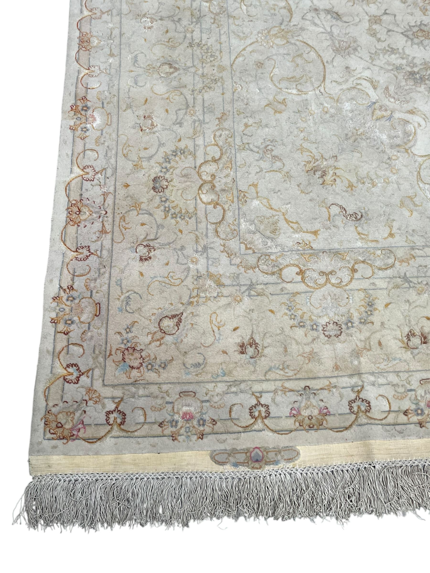 Persian Mahal densely knotted ivory ground carpet, floral rosette medallion surrounded by interlacing leafy branches and palmettes, scrolling border decorated with foliate motifs, within guard stripes, with signature panels to each end
