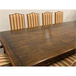 Royal Oak Furniture Co - Jacobean style oak dining table, rectangular top with a lunette carved frieze, acanthus carved baluster cup and cover supports joined by angular stretchers (276cm x 122cm, H81cm), and set ten (8+2) oak framed high back dining chairs upholstered in striped fabric with studded detail, turned supports and stretchers
