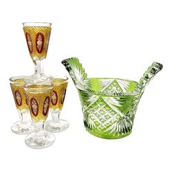 Set of four 19th century bohemian drinking glasses, the funnel bowls with ruby and yellow flashed and cut decoration upon faceted stems and feet, H11.5cm, together with a bohemian green flashed piggin, L20cm