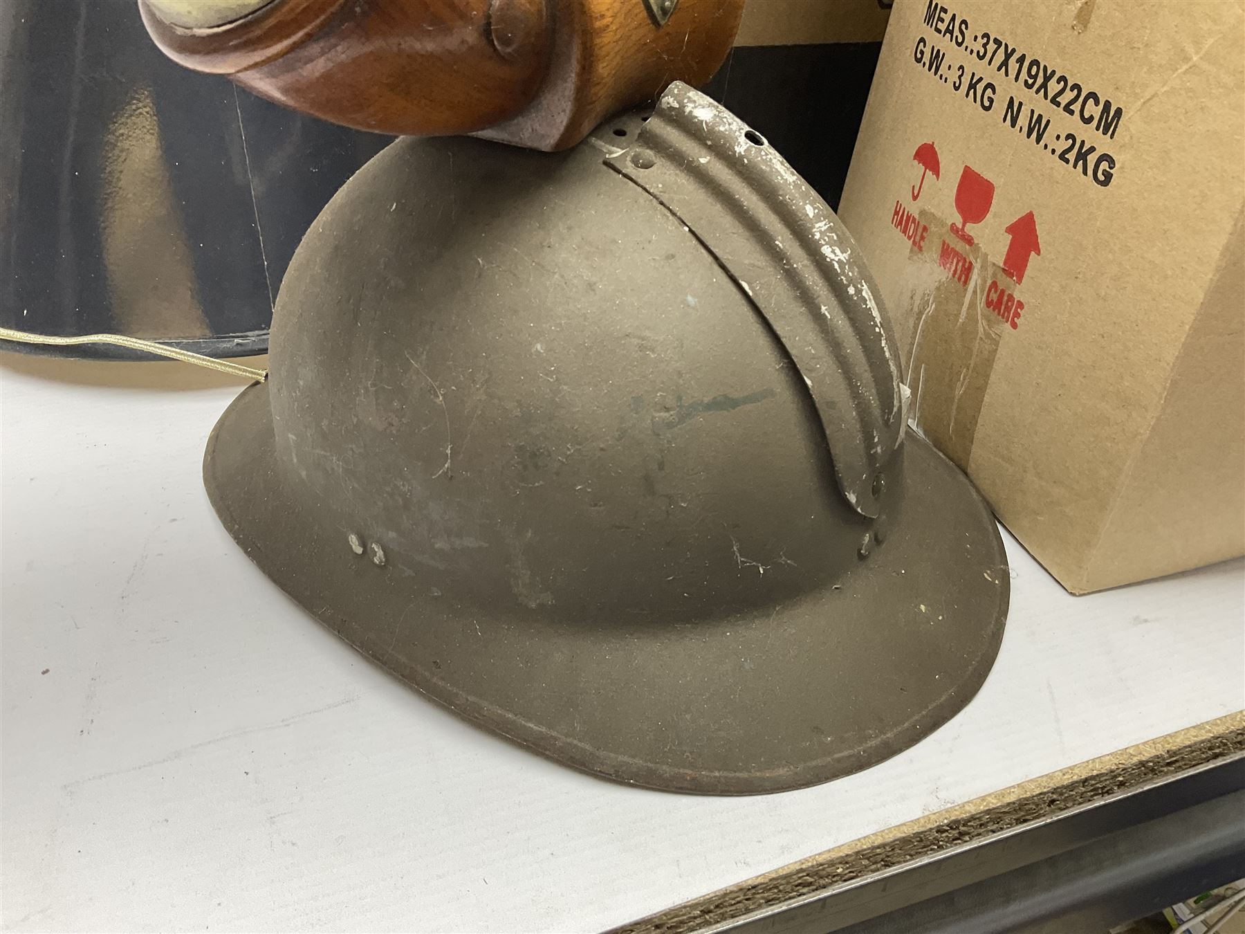 French Adrian helmet and cow horn gong stand; and quantity of lamp shades, etc, helmet H47cm