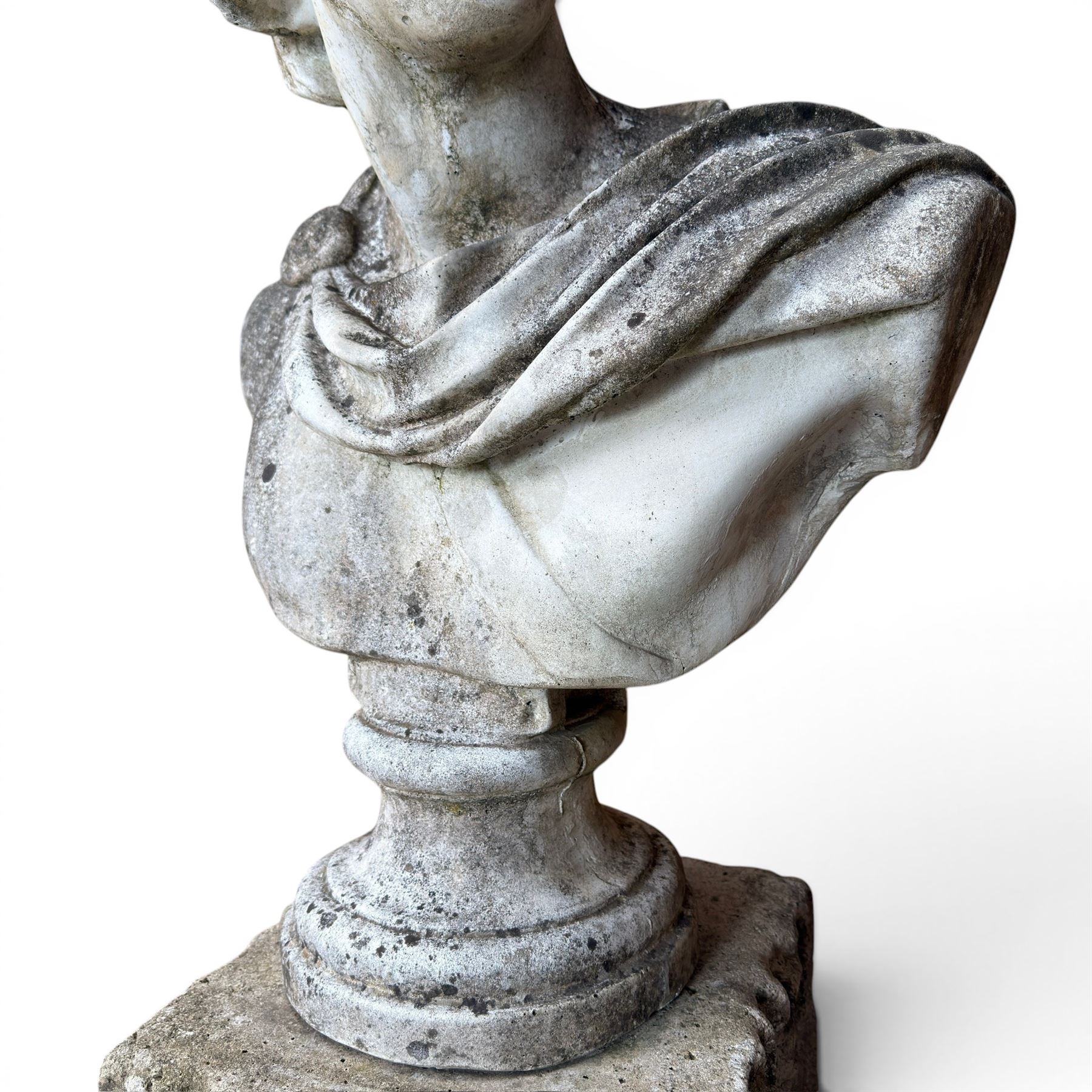 Roman Neoclassical style cast stone bust, weathered finish, raised on textured stone plinth of tapering form