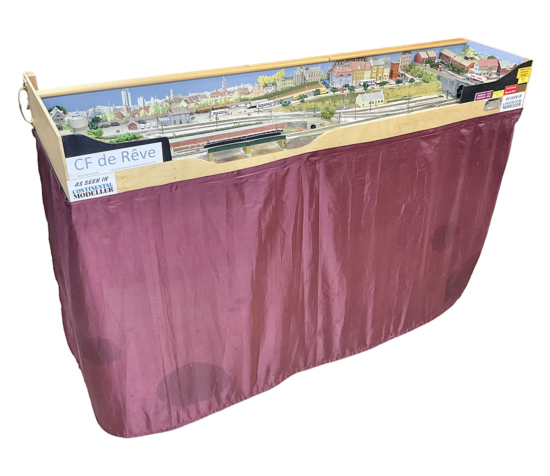 'Z' gauge continental scenic layout with folding legs, various loops of track and sidings with overhead cables, buildings including water tower, tunnels, roads with motor vehicles and figures, trees, haven with boats, backdrop diving wall hiding control units 150 x 50cm