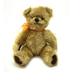 Chad Valley Hygienic Toys teddy bear c1950, kapok filled mohair plush body with original factory given yellow neck ribbon, jointed limbs with velvet paw pads, glass eyes and vertically stitched nose and mouth, blue/white printed label to side seam H12