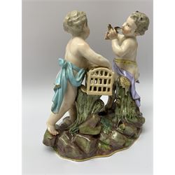 Early 20th century Meissen figure group, modelled as a young satyr releasing a bird, whilst young girl stands with open cage, upon naturalistically modelled base, with blue underglaze crossed sword mark beneath, H15.5cm