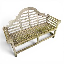 Lutyens design weathered teak garden bench with matching two-tier table, the bench with shaped arched and slatted back over rolled arms and slatted seat