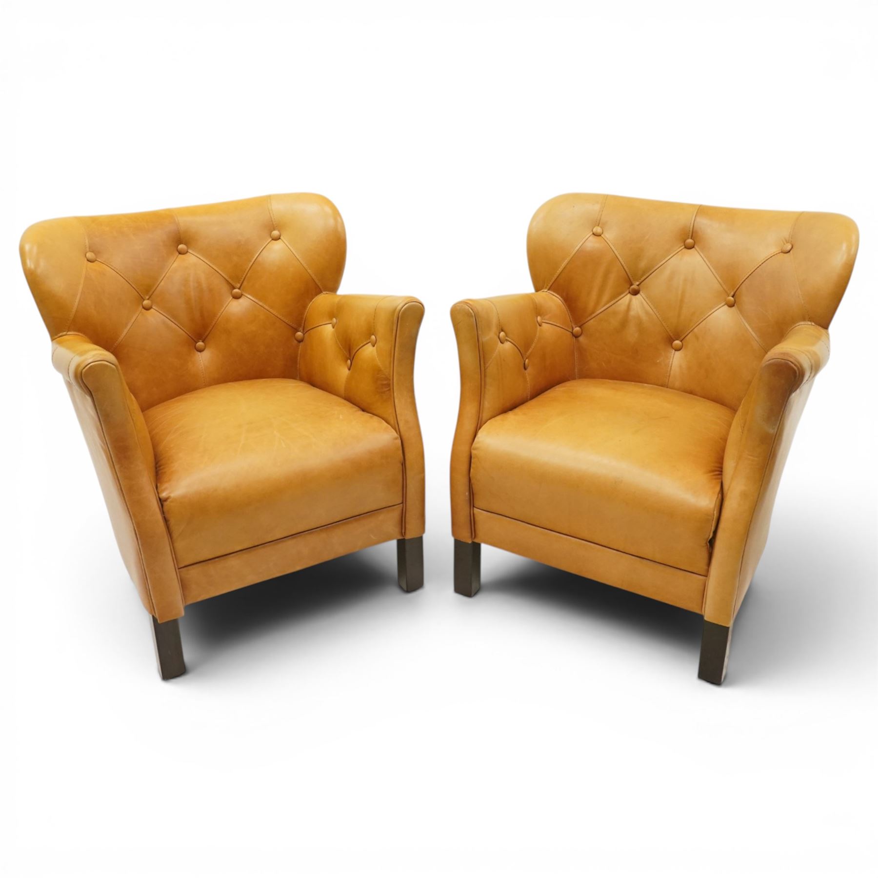 John Lewis - Pair of ochre leather tub chairs, downswept arms, button back and arms, raised on dark supports 