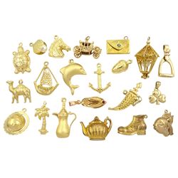 Twelve 18ct gold pendant / charms including horses head, dolphin, turtle, boat, acorn, spinning world globe and dagger, eight 9ct gold charms including stirrup, shamrock, boot, fish, carriage, lantern and clam and a gilt slipper