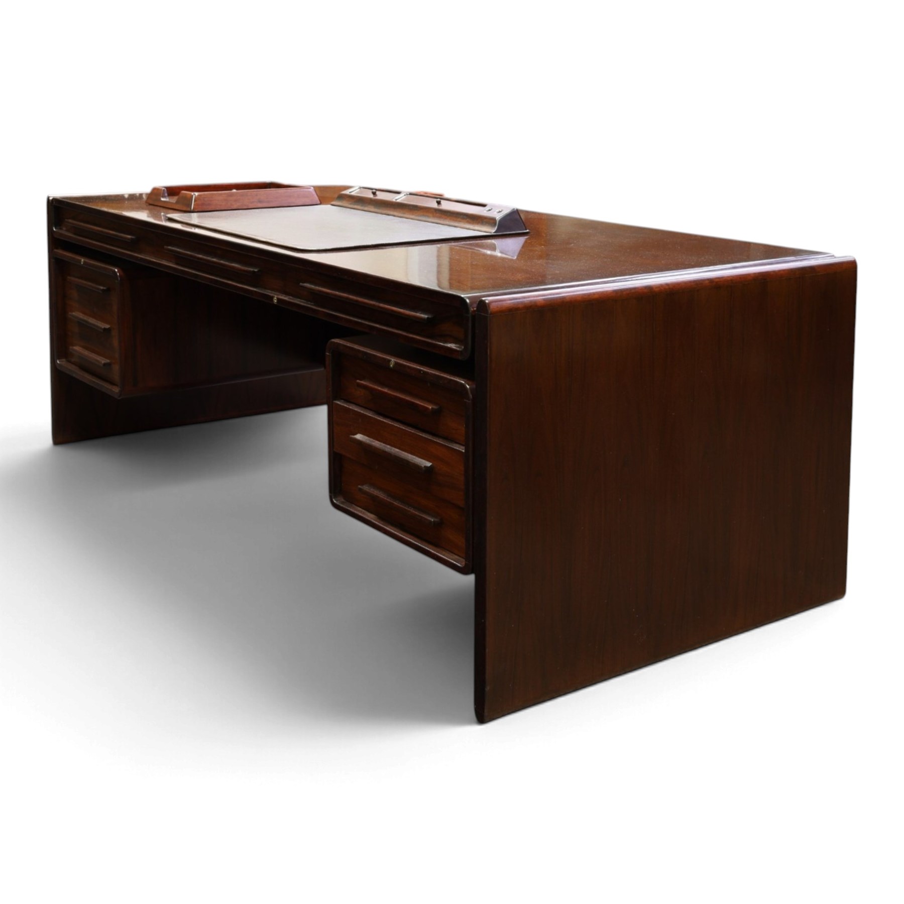 Dyrlund - Santos rosewood office suite, comprising an executive desk and cream leather upholstered swivel chair, the desk with a broad rectangular top with rounded corners, leather writing surface, pen compartments and letter tray, three lockable frieze drawers with fitted interiors above a central kneehole flanked by floating drawer pedestals, the left housing a filing drawer and the right three compartmented drawers, with a full width modesty panel to the reverse, chair raised on a castor base, H 116cm, W 62cm, D 74cm