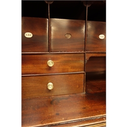  Early 19th century mahogany Estate cupboard, tambour front with an arrangement of twelve drawers including alphabetical open drawers, above brushing slide and single cock beaded drawer, square tapering supports with spade feet, W97cm, H115cm, D46cm  