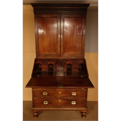  George lll mahogany bureau bookcase, projecting dentil cornice above blind fret frieze, two panelled doors with boxwood and ebony detail stringing enclosing shelves, two candle slides, fall front with a well fitted interior, drawers, pigeon holes and cupboard, four graduating drawers, turned feet, W110cm, H216cmcm, D60cm  
