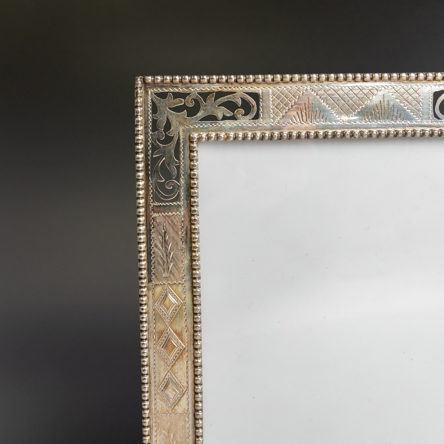 Indian silver double folding photograph frame, of rectangular form with beaded border and pierced decoration, H19.5cm