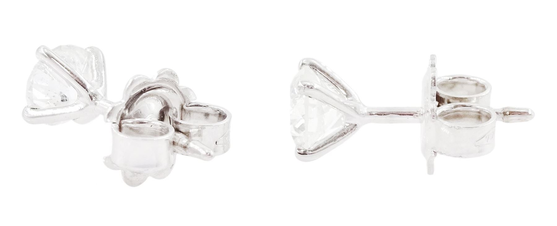 Pair of 18ct white gold diamond earrings, each stud set with a round brilliant cut diamond, in a four claw setting, stamped 750, total diamond weight approx 1.10 carat