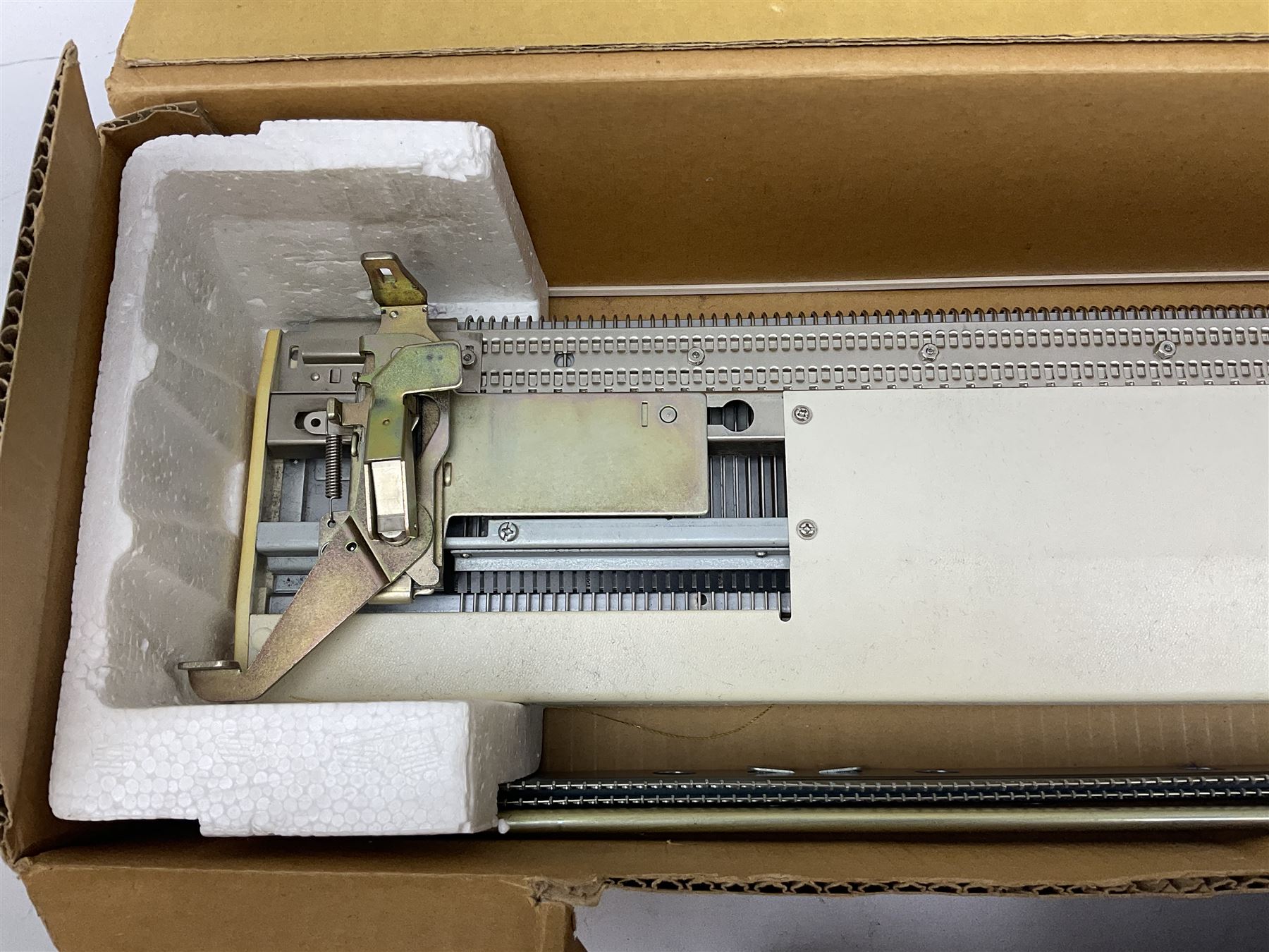  Brother cased knitting machine model KH-890 together with Brother Ribbing attachment model KH-850, knitting machine yarn cones in assorted colours, selection of knitting patterns etc