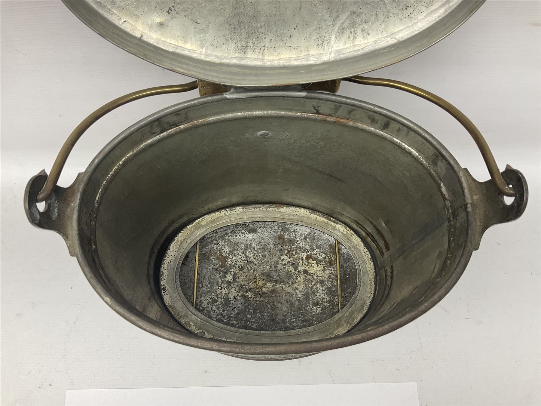 Late 19th/early 20th century steel and brass dairy pail or can, of oval form with swing handle, brass plaque to front and hinged cover inscribed 'F & T Ross Ltd Dairy Outfitters Hull', and 'New Milk F Clappison Dairy Farmer Hull', not including handle H30cm