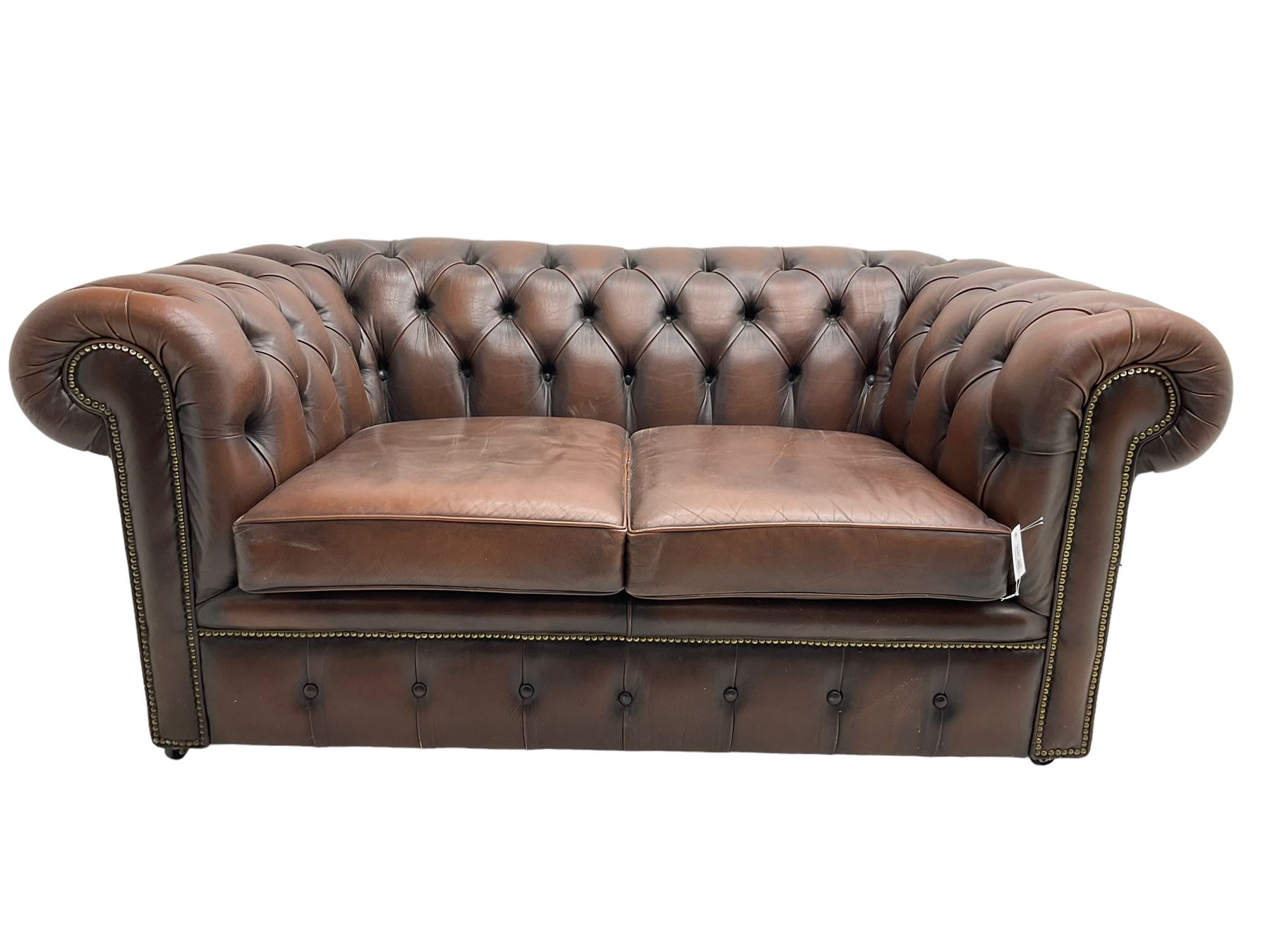 Chesterfield two seat sofa, upholstered in brown buttoned leather