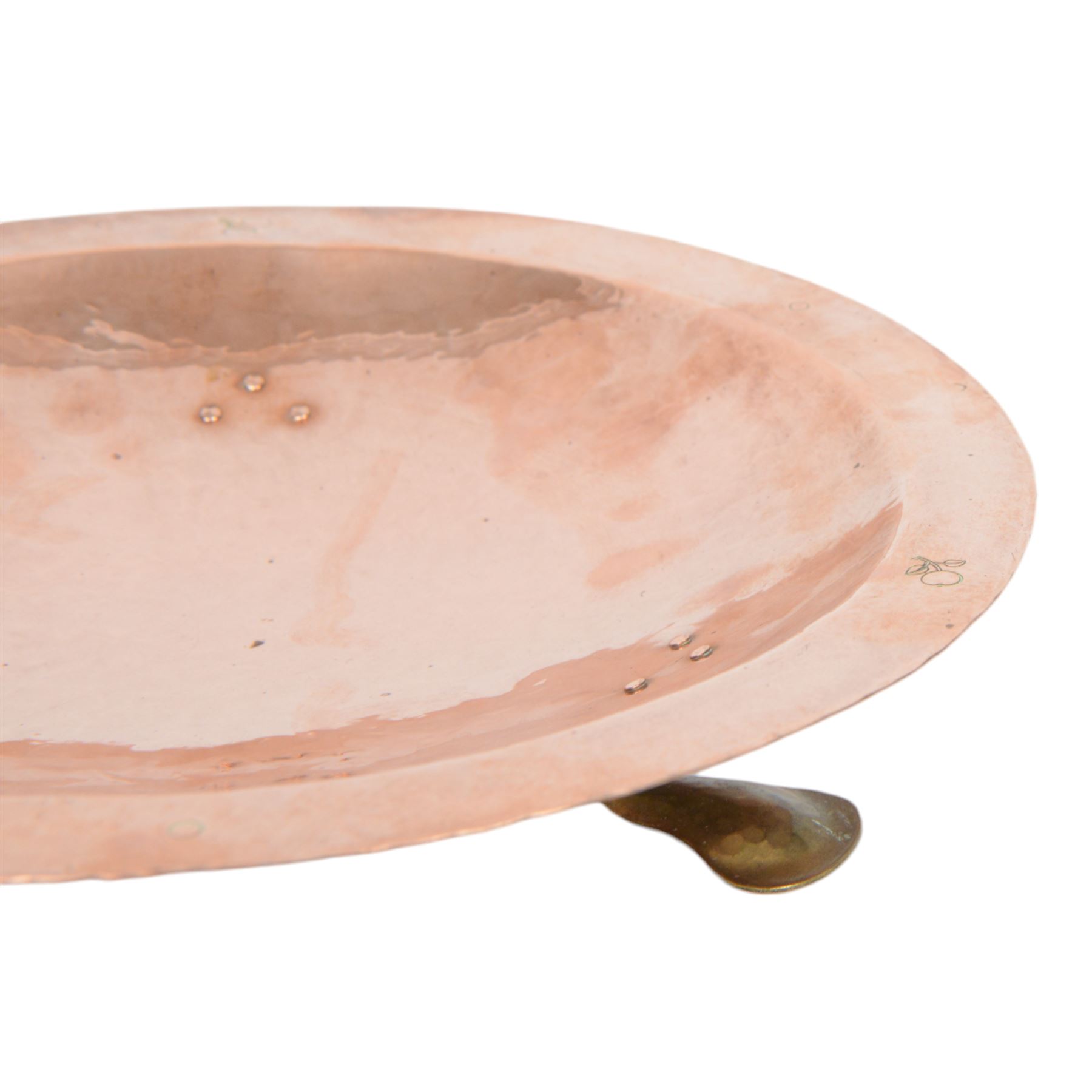 Arts and Crafts Birmingham Guild of Handicraft copper bowl, of circular form, the broad rim stamped with circles and fruiting sprigs, raised upon three cast brass feet, with impressed mark beneath The Birmingham Guild Ltd England, D30cm