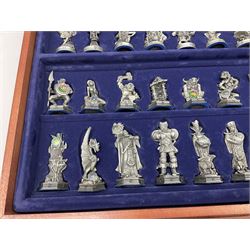 Danbury Mint 'The Fantasy of the Crystal' chess set consisting of mythical pewter chess pieces within a wooden case with chess board lid, together with 16 additional chess pieces in a wooden display case.