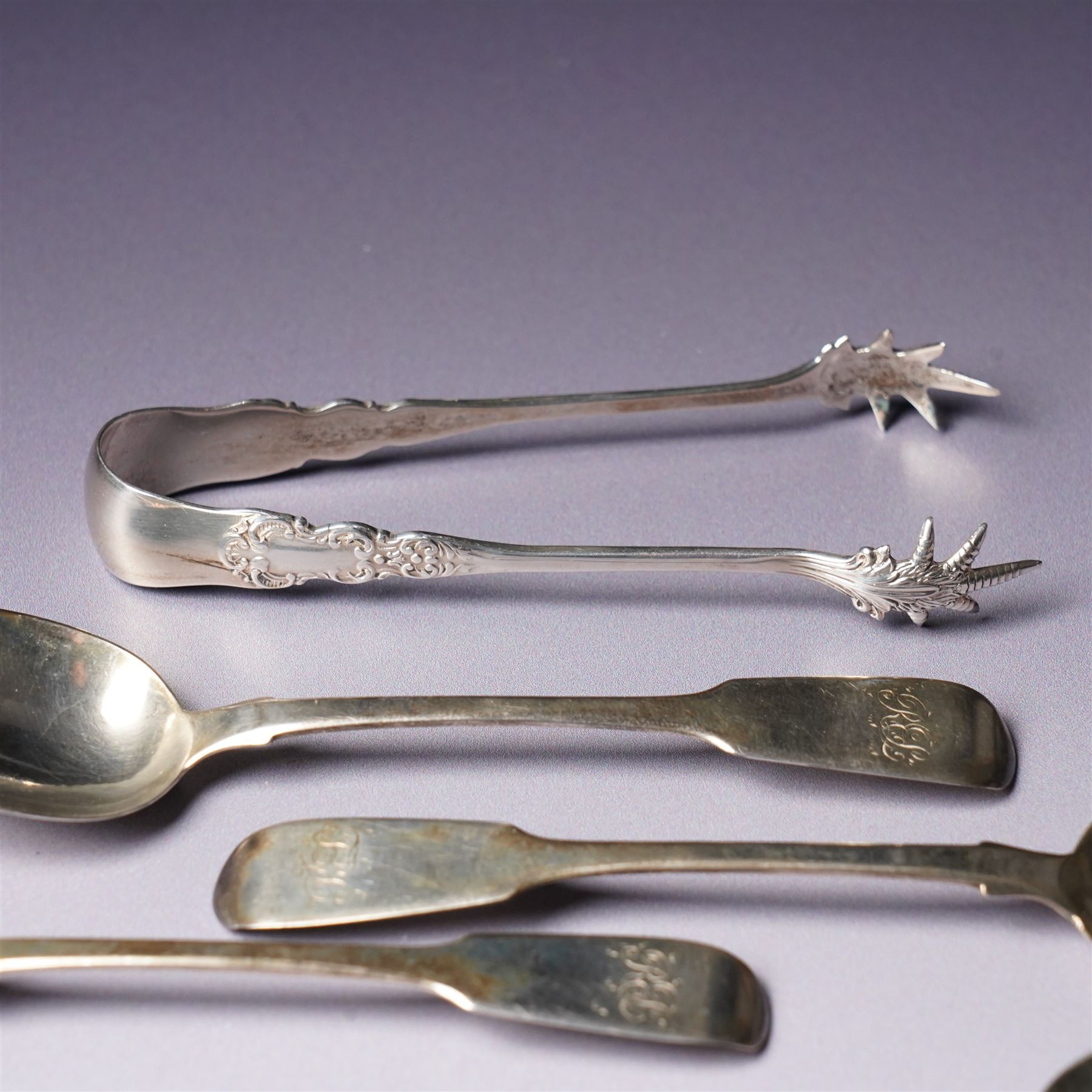 Set of six George IV silver fiddle pattern tea spoons London 1827 engraved with initials and a pair of later sugar tongs