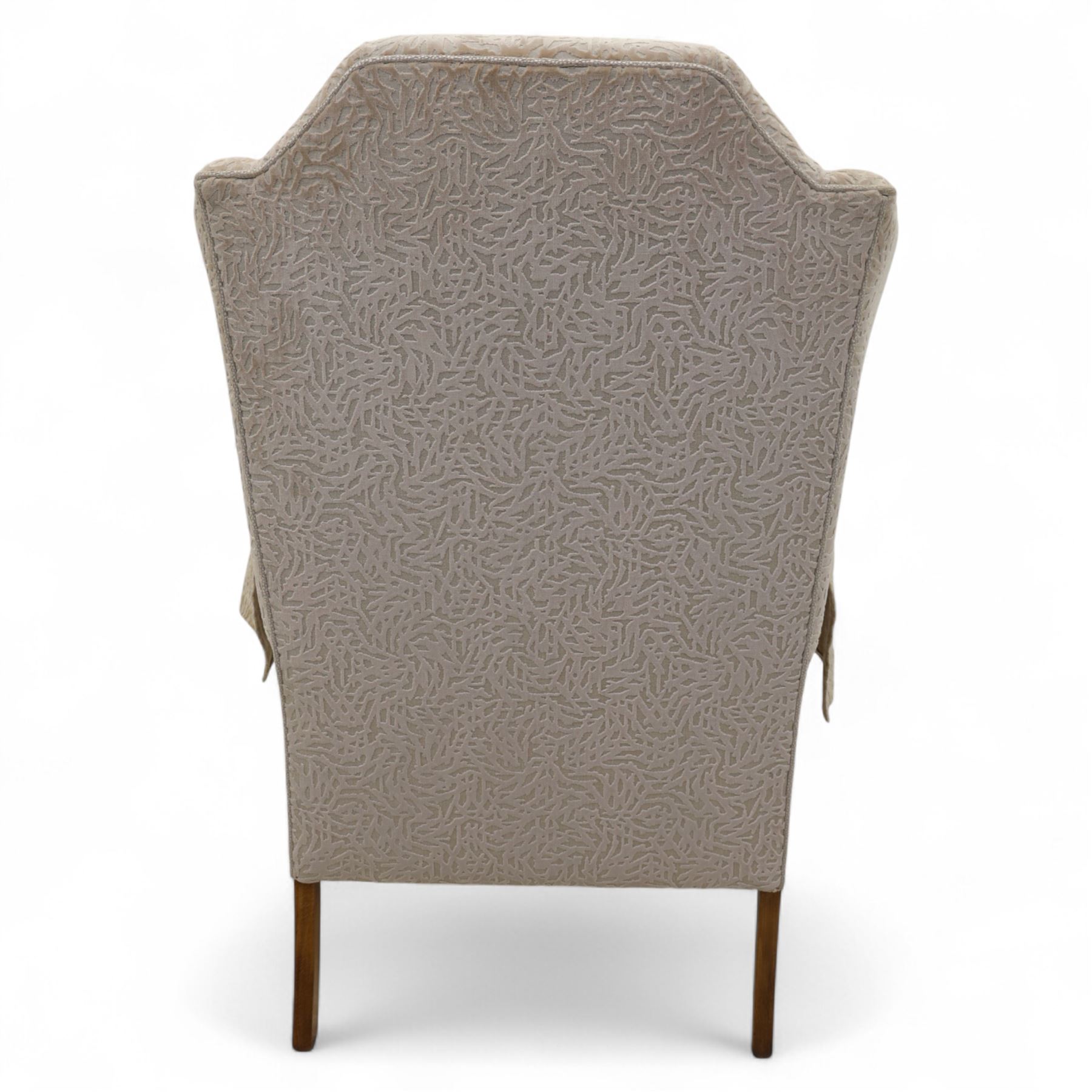 Late 20th century wingback armchair, upholstered in beige embossed fabric with brass stud edging, on cabriole legs and splayed rear legs