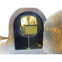  20th century mantel clock in domed oak case, silvered Arabic dial and twin train movement chiming the quarter hours on rods, H23 cm and another striking the half hours on a coil, H24cm (2)    