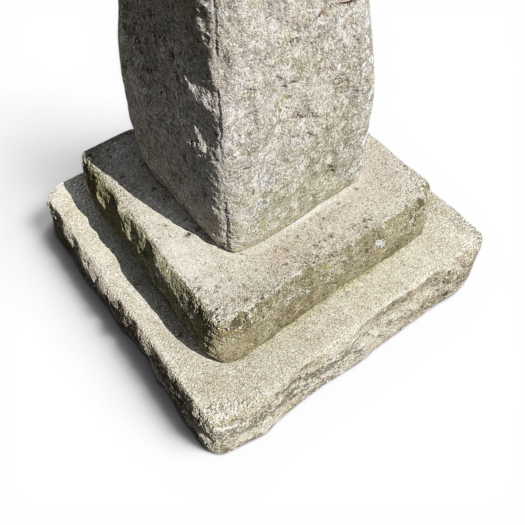 Early 20th century composite three-piece stone birdbath, square dished top on tapering pedestal and stepped base