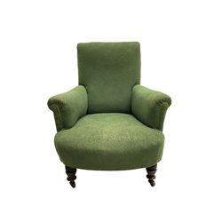 Victorian armchair, upholstered in foliate patterned laurel green fabric, raised on ring turned supports with castors