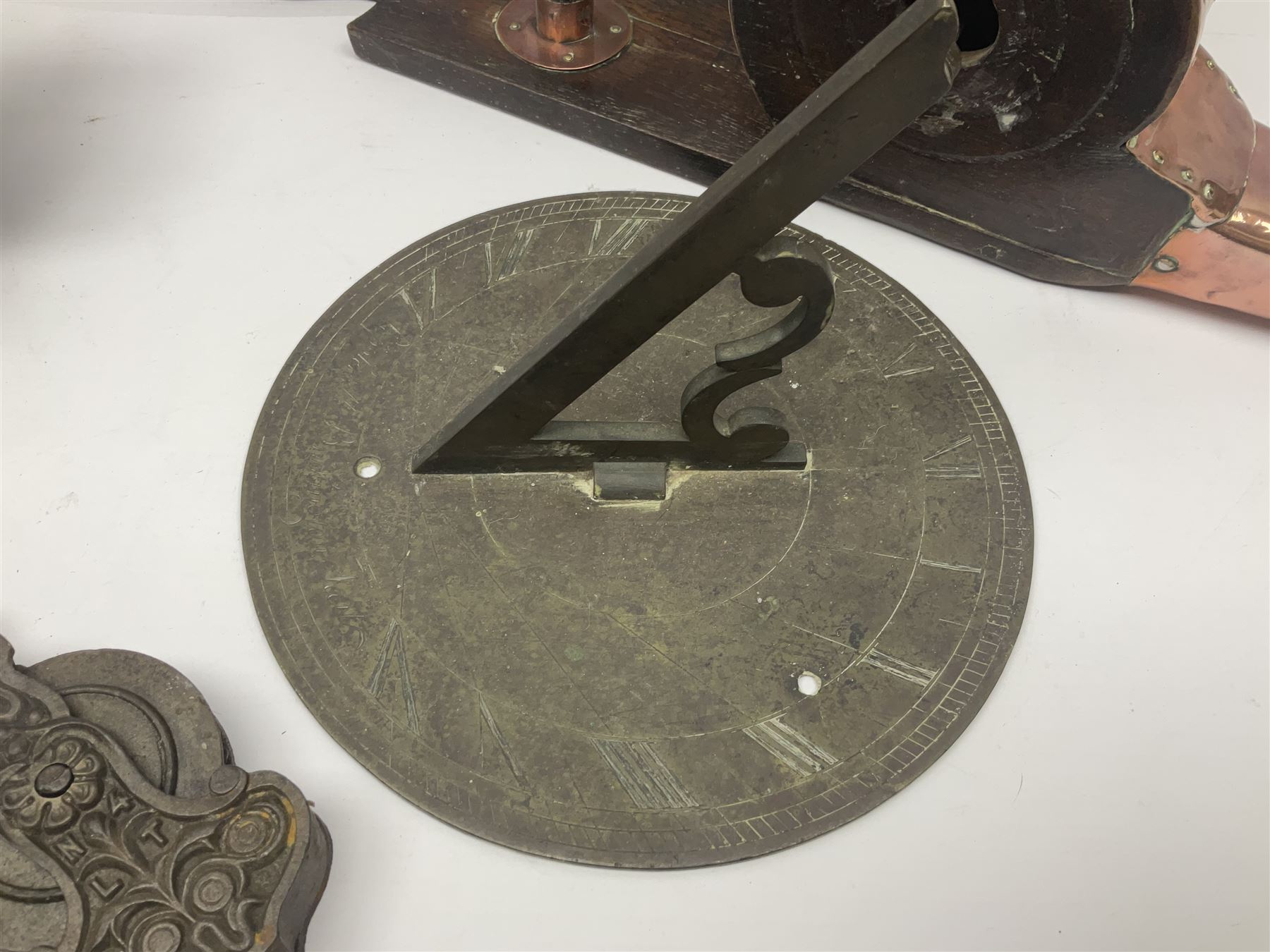 Two 19th century copper tankards, one with weighted wooden base, together with copper and wooden mechanical bellows, sundial and other metalware 