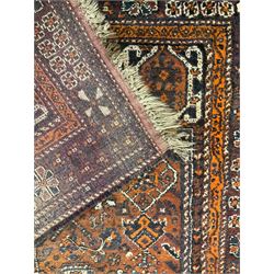 Baluchi red and amber ground rug, field decorated with central geometric lozenge surrounded by stylised plant motifs, guarded border with repeating plant and flower head designs