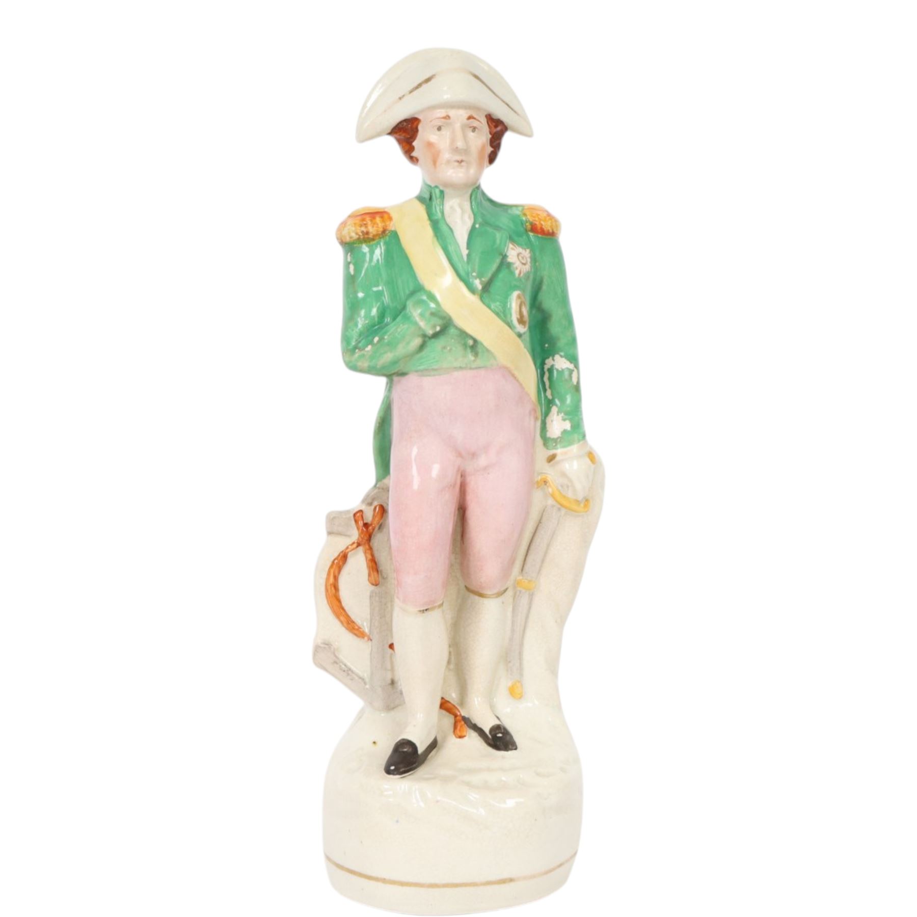 Rare mid 19th century Staffordshire pottery figure of Admiral Lord Nelson, modelled standing in uniform with green tunic, beside anchor, H27cm