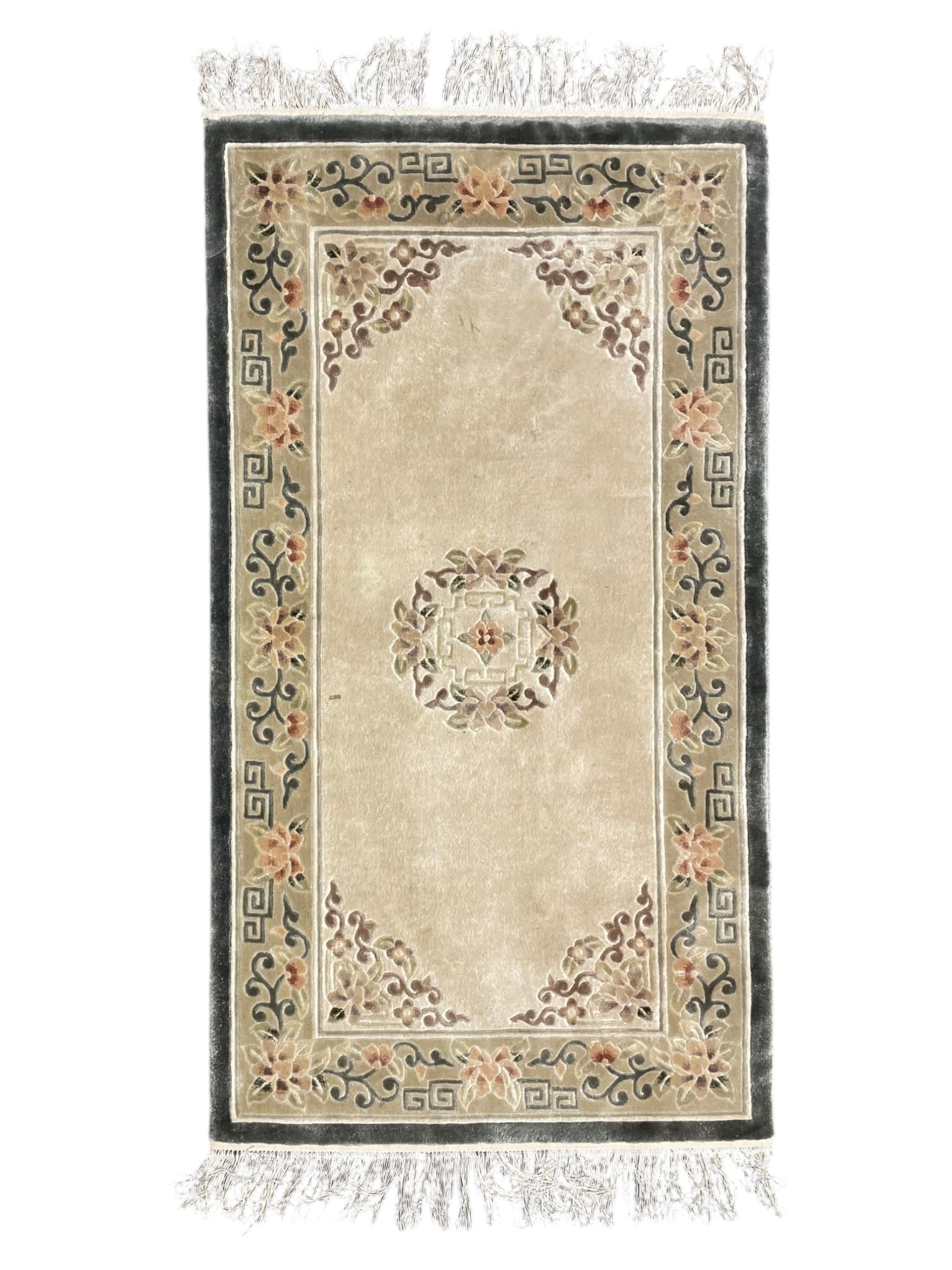 Chinese washed woollen camel ground rug, circular medallion surrounded by scrolls, the border decorated with birds and trailing floral decoration (248cm x 155cm); Chinese washed woollen pale green ground rug (125cm x 69cm); Persian design rug (186cm x 121cm) (3)