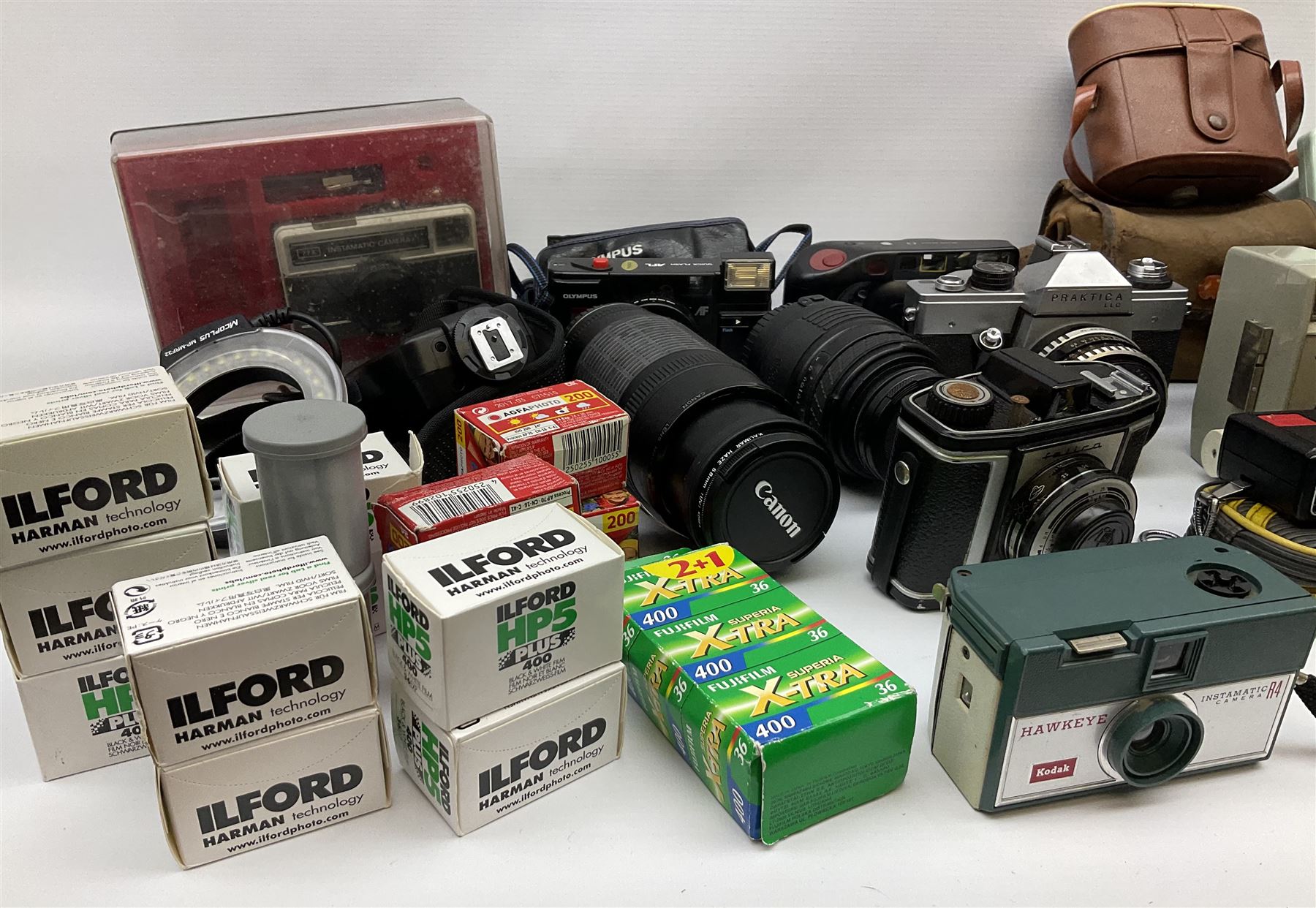Vintage and later cameras, lenses, accessories and darkroom equipment including Zenit 12XP camera, Praktica BX20 camera fitted with 'Sigma Zoom Master 1:3.5-4.5 f=35-70mm' lens, Praktica LLC camera fitted with 'Carl Zeiss Jena Pancolar 1.8/50' lens, Canon Zoom Lens 'EF 100-300mm 1:5.6', various Jessop and other makers darkroom items including safelight (Red), universal duo tank, multi-mask enlarging easel etc, in three boxes