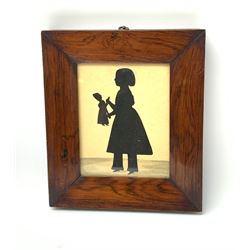 A Victorian silhouette depicting a young girl holding a doll, within rosewood frame, overall H20.5cm L17.5cm.