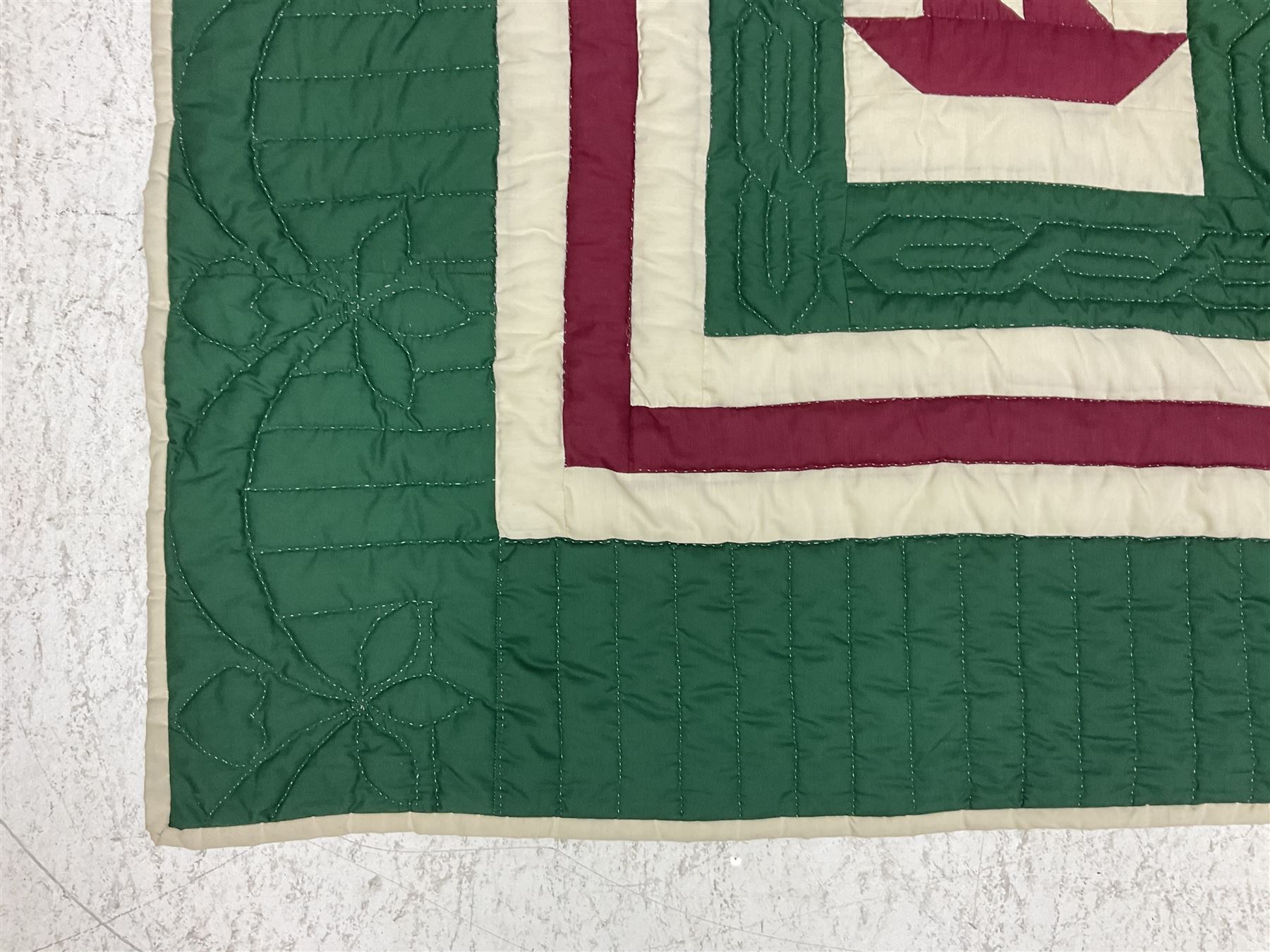 20th century quilt, with repetitive ship design to the centre within a cream red and green boarder, 227cm x 222cm