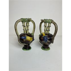 Pair of 19th century Portuguese Palissy style Majolica puzzle jugs, attributed to Manuel Mafra, with mossy rim and pierced lattice neck, twin handles in the form of snakes and the body decorated with frogs, lizards, and moths on a mottled brown glazed ground, unmarked, H20cm