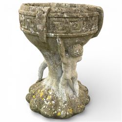 Cast stone urn with two figures supporting the bowl