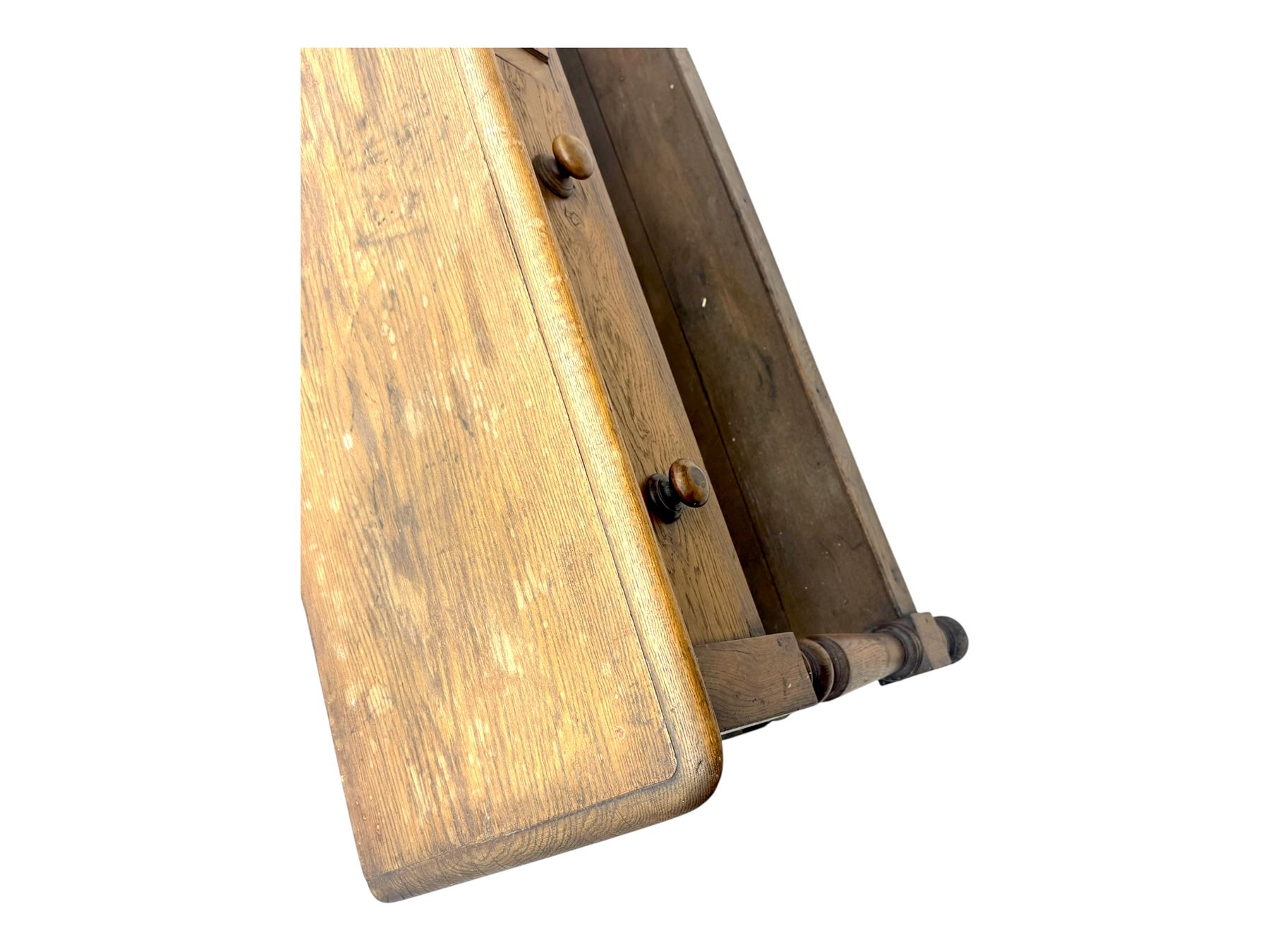 Late 19th century oak potboard dresser base, rectangular top over two frieze drawers with turned wooden handles, raised on four ring turned and tapering supports with block feet, united by a full-width lower potboard