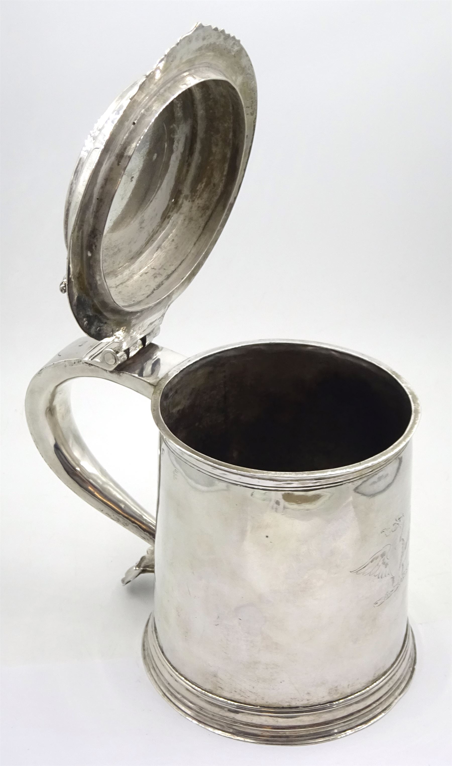 Queen Anne silver tankard, of plain tapering cylindrical form, with stepped and flat-domed cover, twit cast thumbpiece and curved handle, the body engraved with eagle crest, hallmarked Abraham Barachin, Hull, circa 1706, the body and cover stamped once with makers mark and twice with town mark, H18cm, approximate weight 21.46 ozt (667.7 grams)
