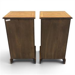Pair of burr oak bedside tables with campaign brass handles, inlaid and crossbanded top, above four graduating drawers with cockbeaded edges, raised on a plinth base 