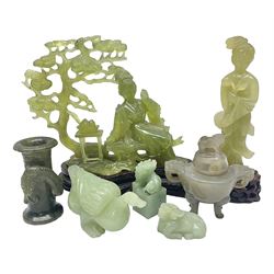 Group of seven Chinese hardstone carvings, to include figure of a standing lady upon a carved wood base, carved duck, figure of a lady under a blossoming tree etc  