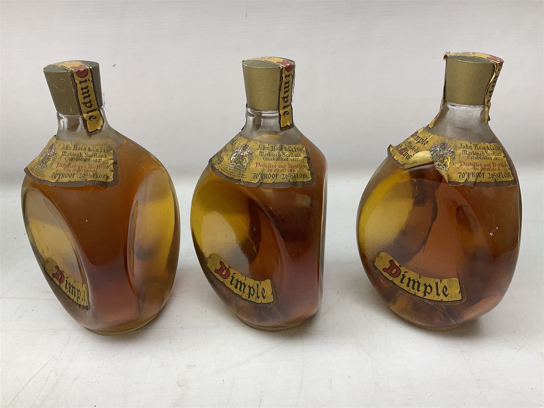 Four bottles of Haig's Dimple Old Blended Scotch whisky, all 26 2/3 Fl.OZs, 70 proof, one in original box and a bottle of East India 1961, Madeira, unknown contents and proof
