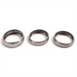 Silver pepper grinder, sifting ladle, silver handled spoon and eight silver napkin rings, all stamped or hallmarked