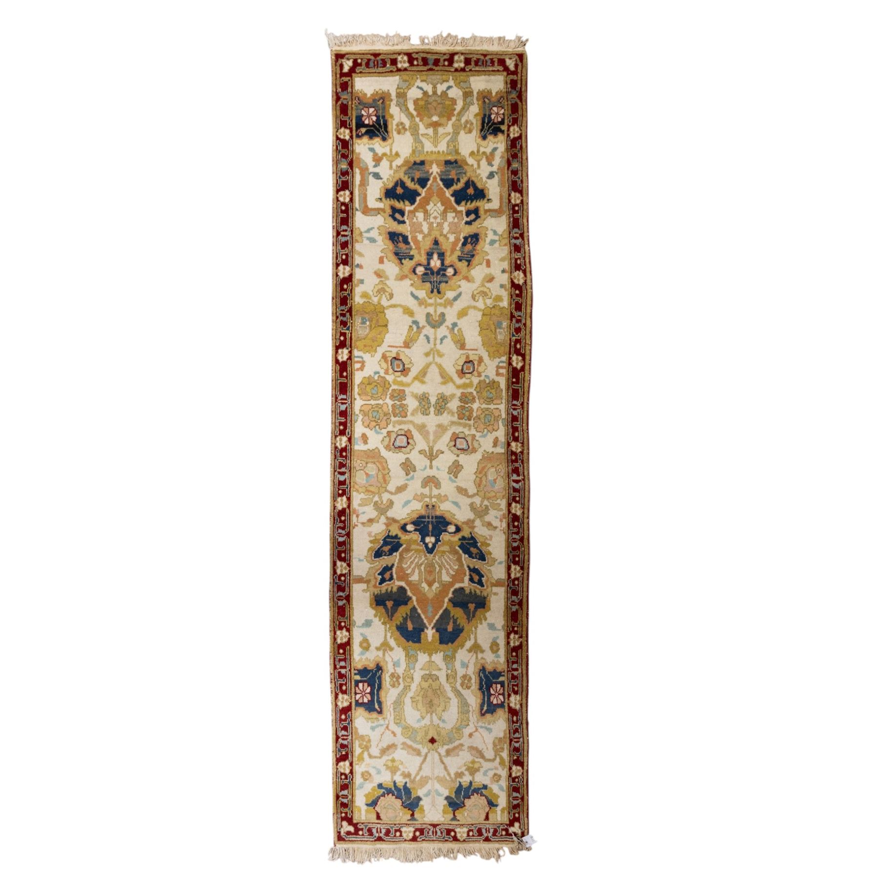 Agra wool runner, cream field decorated with large stylised palmettes, scrolling vines and flowerheads, enclosed by red main border with foliate motifs and fringed ends