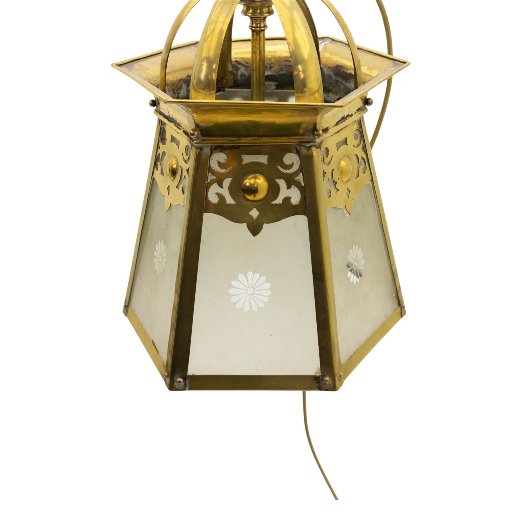 Arts & Crafts brass hall lantern, circa 1900, of hexagonal tapering form with open dome top support and pierced foliate detail above frosted glass panels with flower head detail, H41.5cm D29cm