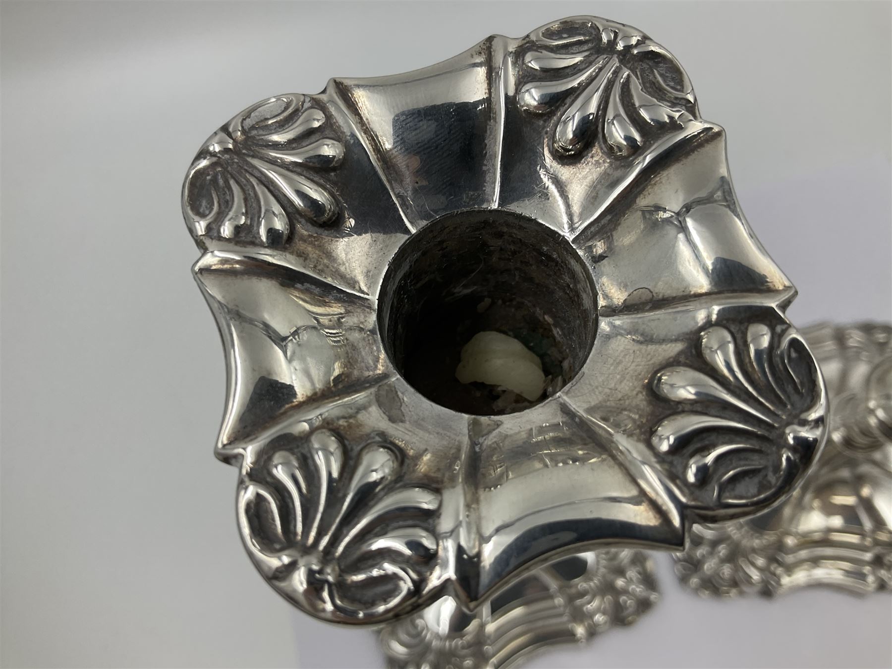 Pair of late Victorian silver mounted candlesticks, each of knopped and part fluted form, upon square stepped base with anthemions to each corner, with conforming sconces, hallmarked to removable sconces and foot, Thomas A Scott, Sheffield 1901, H25.2cm