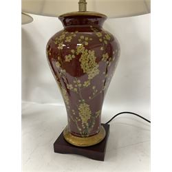 Pair of large table lamps of tapering form, decorated with Japanese blossom on a red ground, upon a square base, including shade H72cm
