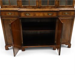 Georgian design mahogany breakfront bookcase on cupboard, projecting cornice over four arched astragal glazed doors, base fitted with three drawers over panelled cupboards, raised on bracket feet
