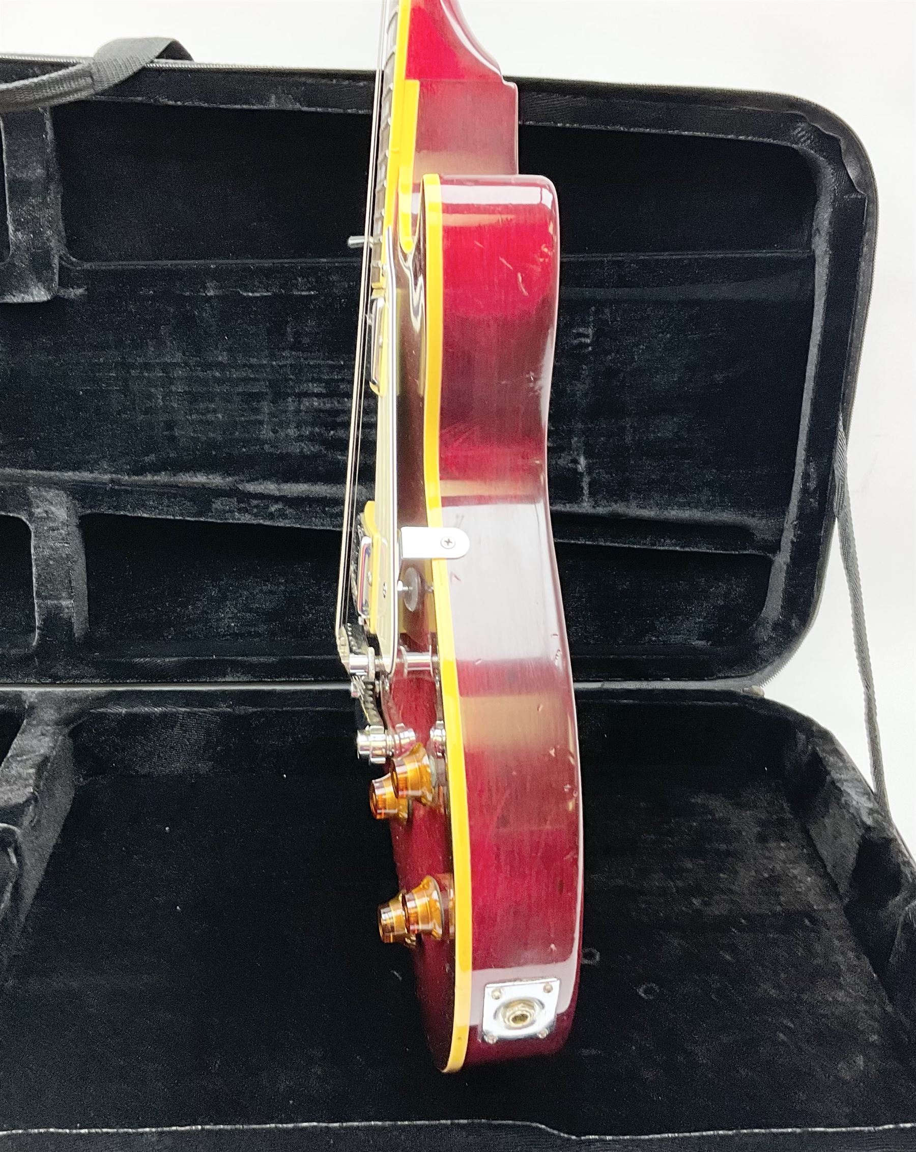 1980s Les Paul Epiphone limited edition cut-away electric guitar by Gibson, the burgundy coloured body with two pick-ups, volume and tone knobs and scratch plate, original tuning pegs, serial no.U6030215, 101cm overall; in modern Kinsman fitted carrying case